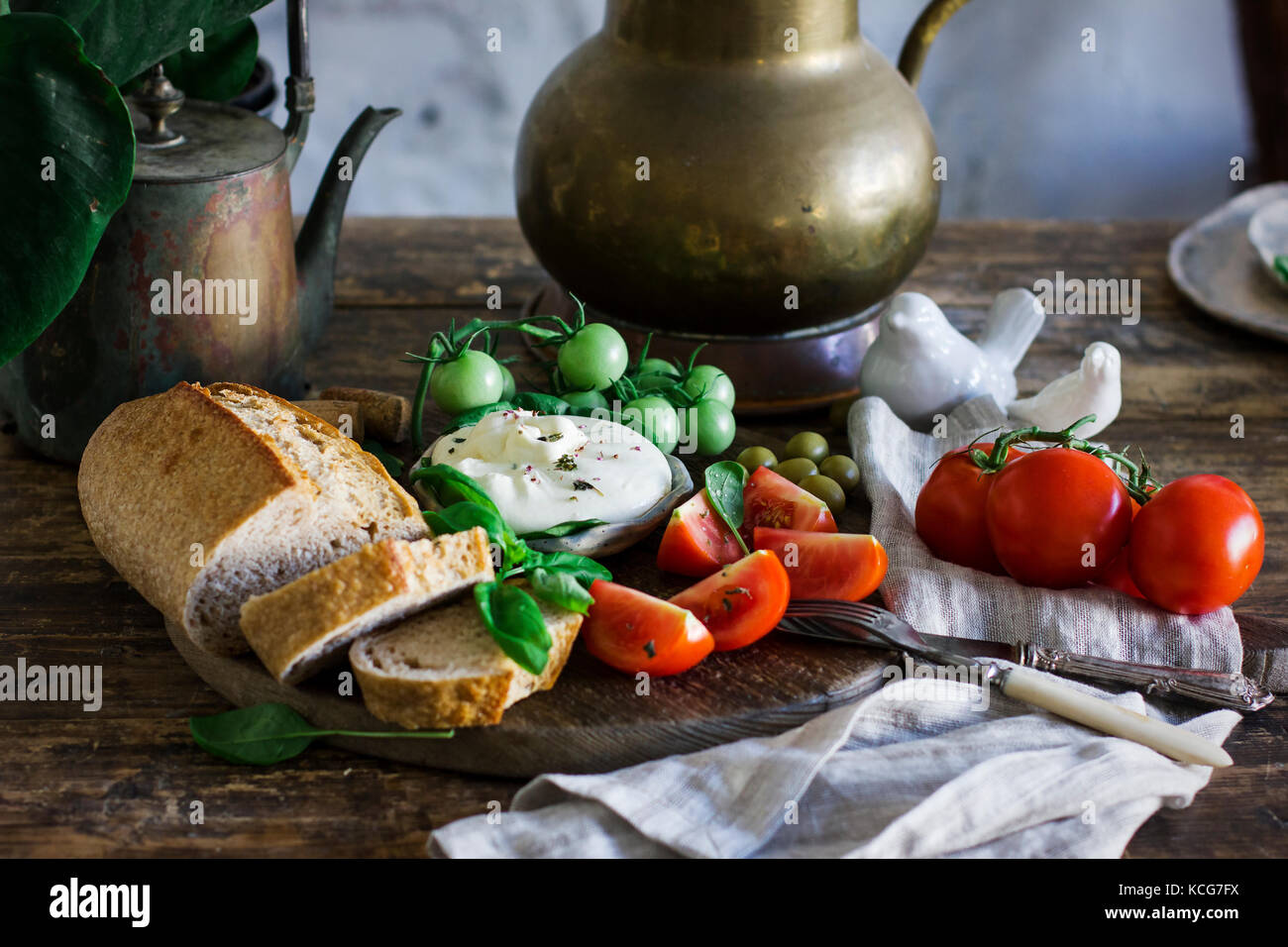 Fresh burrata cheese with tomatoes, Basil and multigrain bread on the