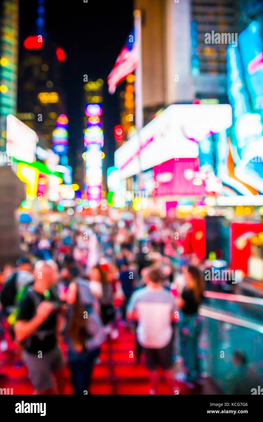 Defocused blur of Times Square in New York City, midtown Manhattan at night with lights and people. Stock Photo