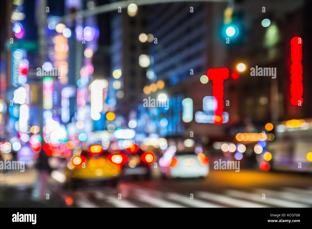 Defocused blur of New York City street in midtown Manhattan at night ...