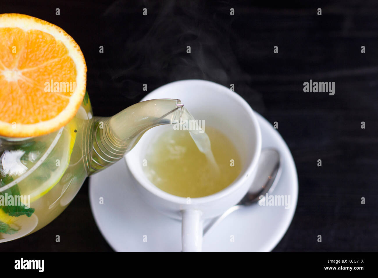 Orange herbal hot tea poured into the cup. Close up Stock Photo Alamy
