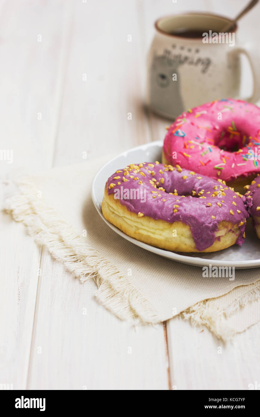Fresh donuts in the white plate on wooden background Stock Photo - Alamy