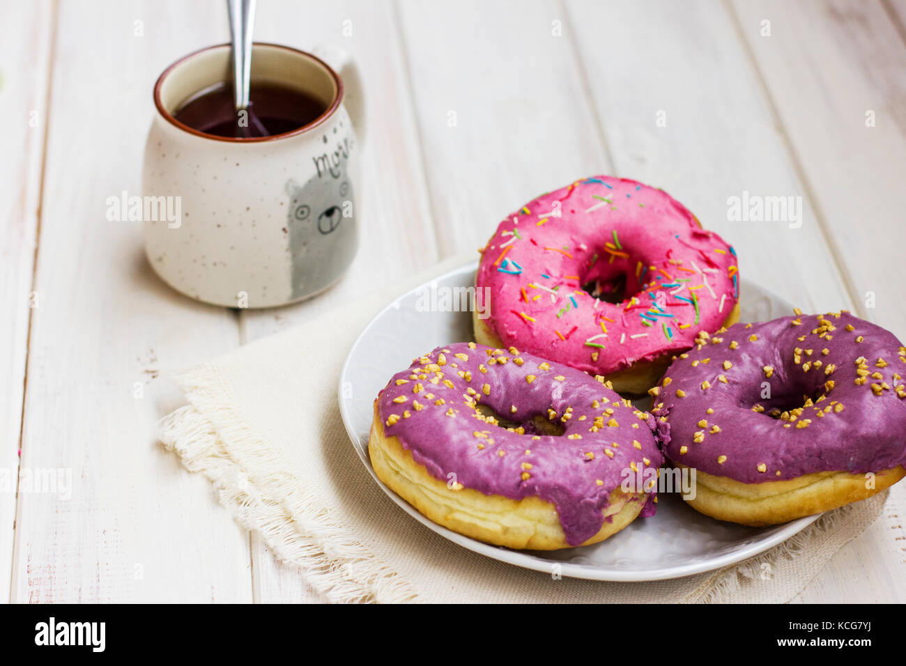 Fresh donuts in the white plate on wooden background Stock Photo - Alamy