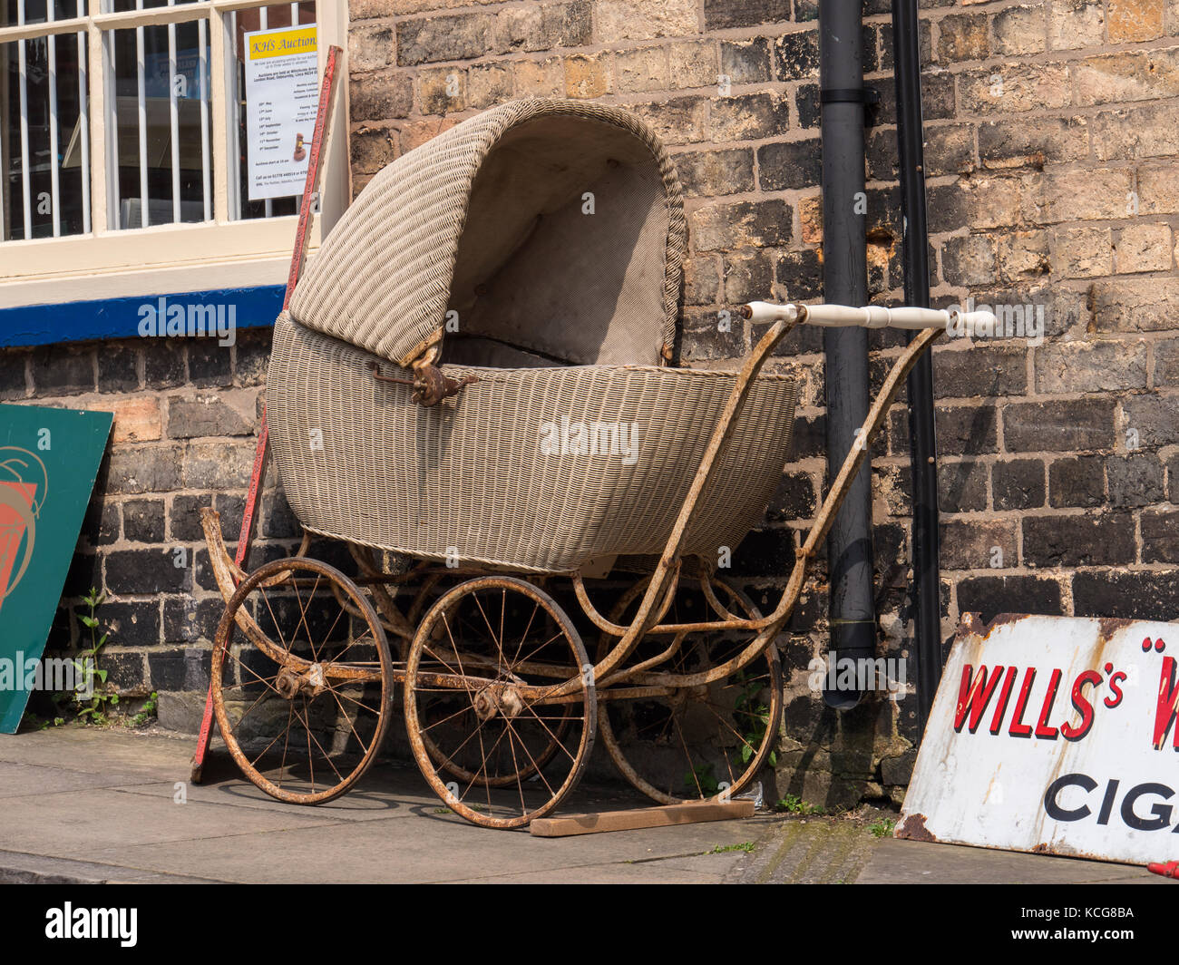An old pram outside Antiques Shop Steep Hill Lincoln Lincolnshire England Stock Photo