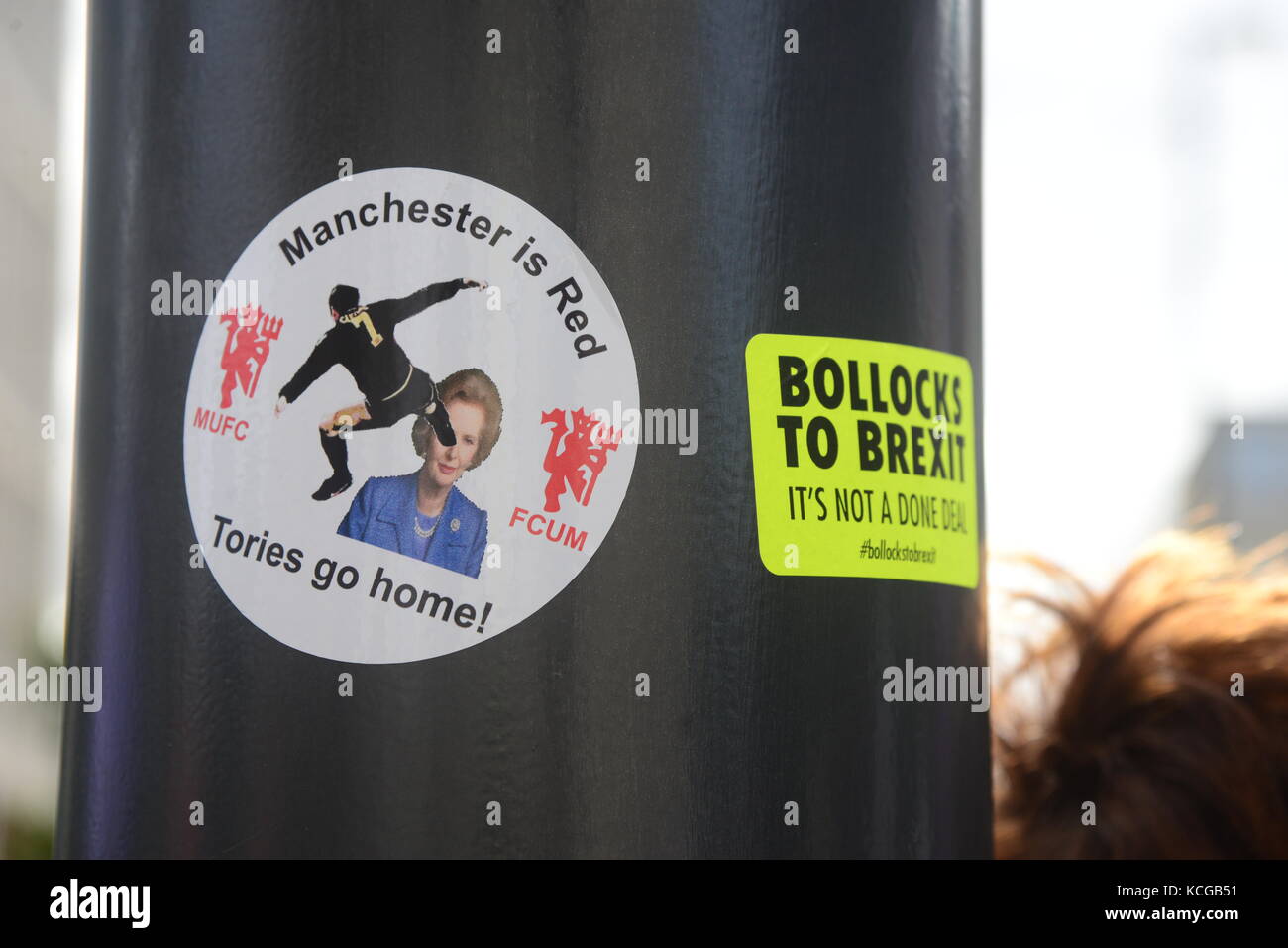 Political stickers on lamp posts Stock Photo