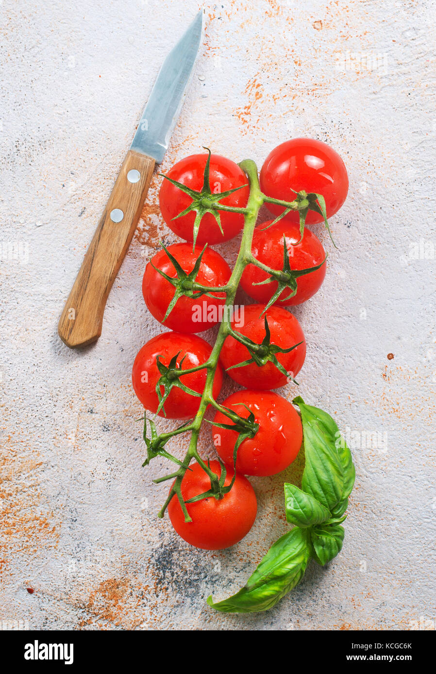 fresh tomato with green basil on a table Stock Photo - Alamy