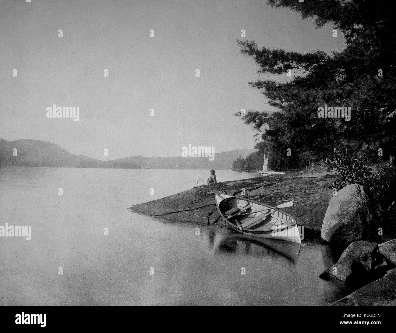 United States of America, man relaxing on the shore and looking at Lake George, before it a rowing boat, New York, digital improved reproduction of a historical photo from the (estimated) year 1899 Stock Photo
