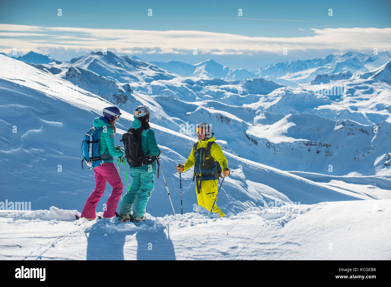 A ski instructor guides two women off piste in the French ski resort of Courchevel. Stock Photo