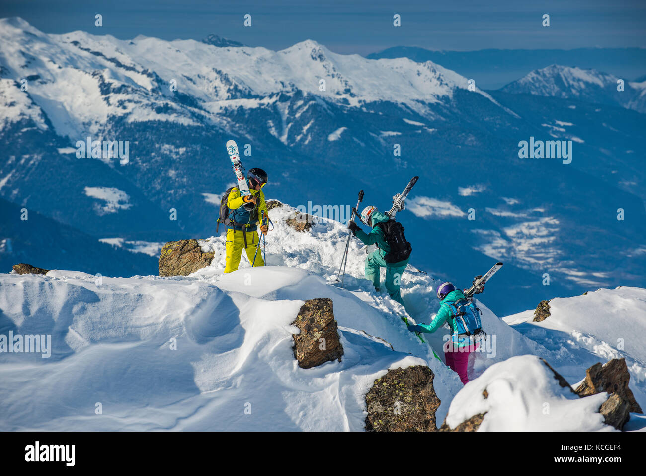 A ski instructor guides two women off piste in the French ski resort of Courchevel. Stock Photo