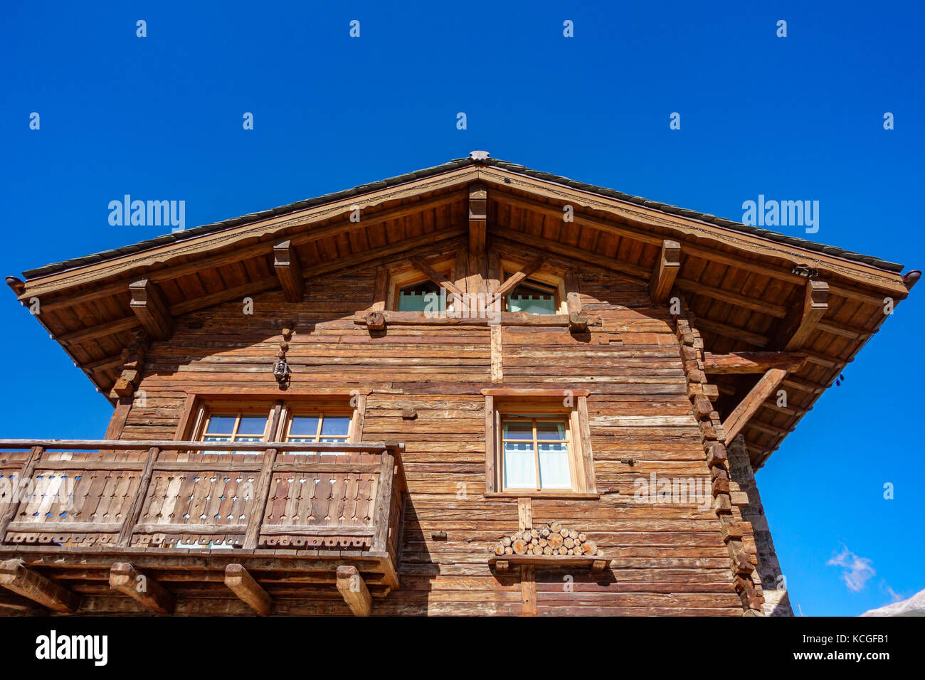 Wooden house with balcony against blue sky Stock Photo - Alamy