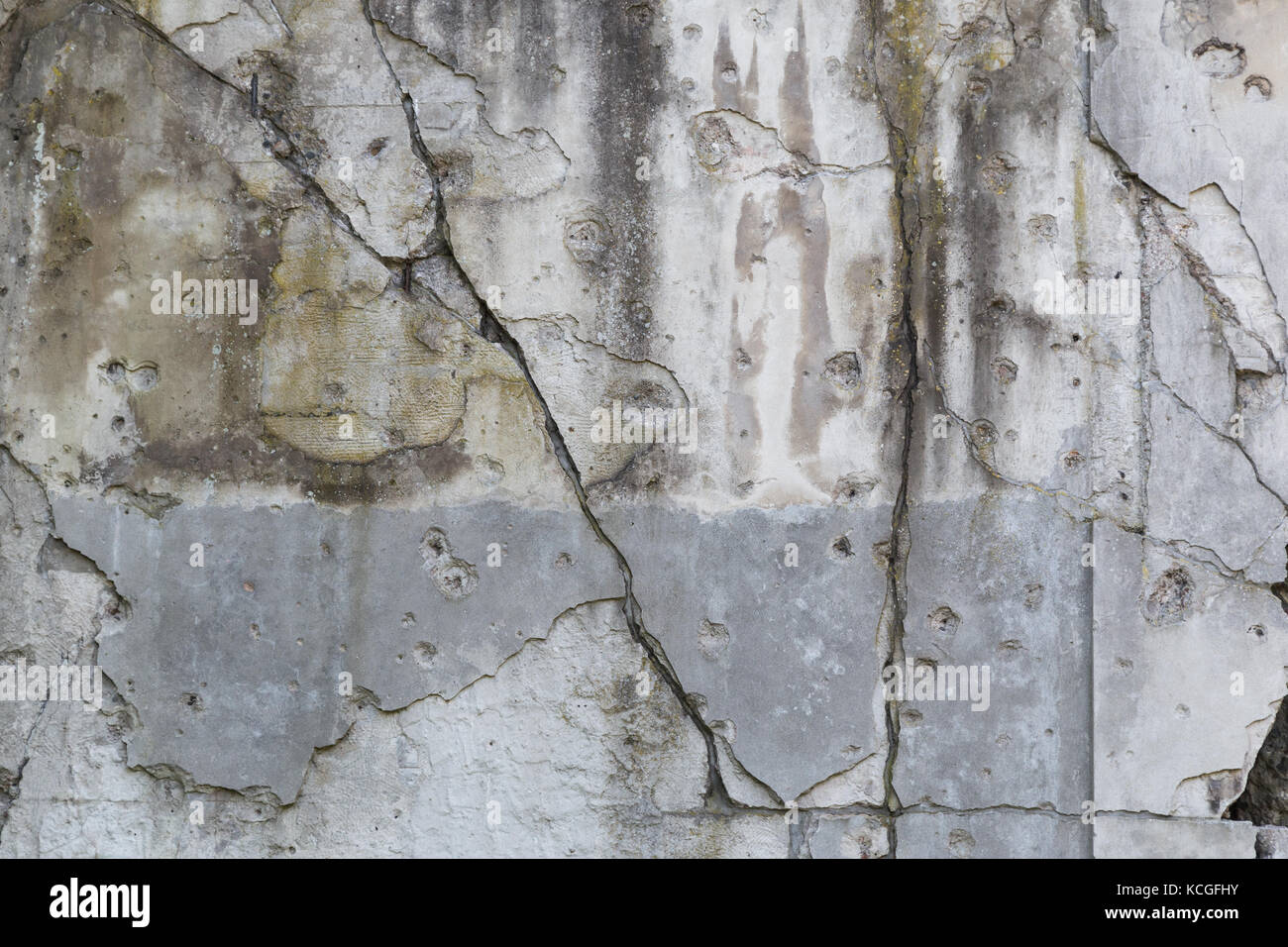 Old, damaged and cracked wall with real bullet holes from World War II in Gdansk, Poland. Background texture. Stock Photo