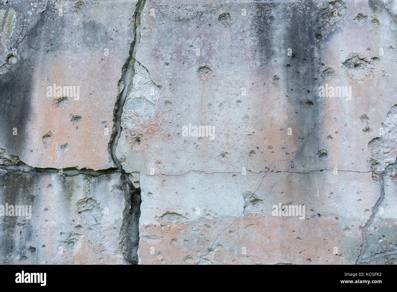 Old, damaged and cracked wall with real bullet holes from World War II in Gdansk, Poland. Background texture. Stock Photo