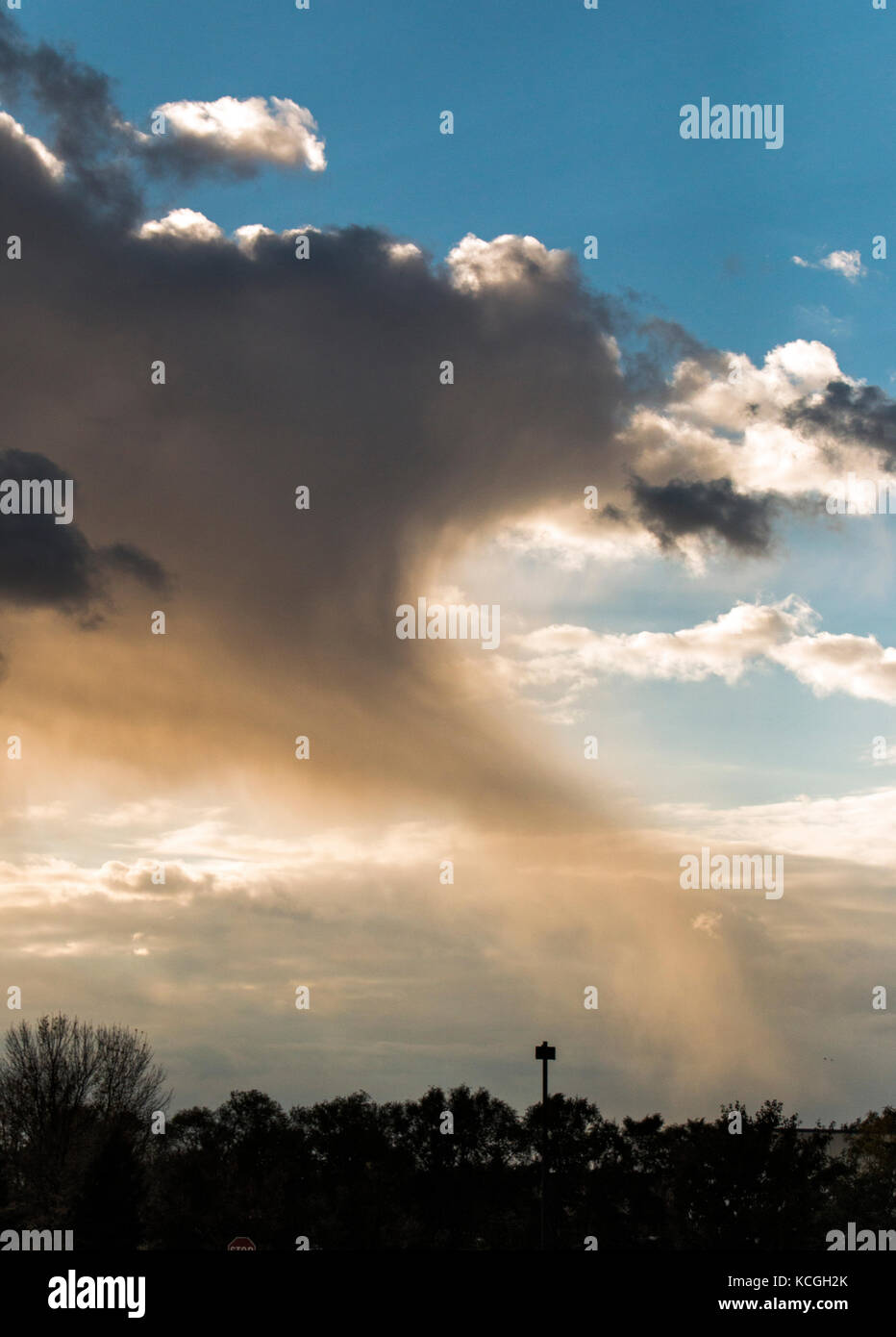 A small tail of precipitation falling from a cloud. Stock Photo