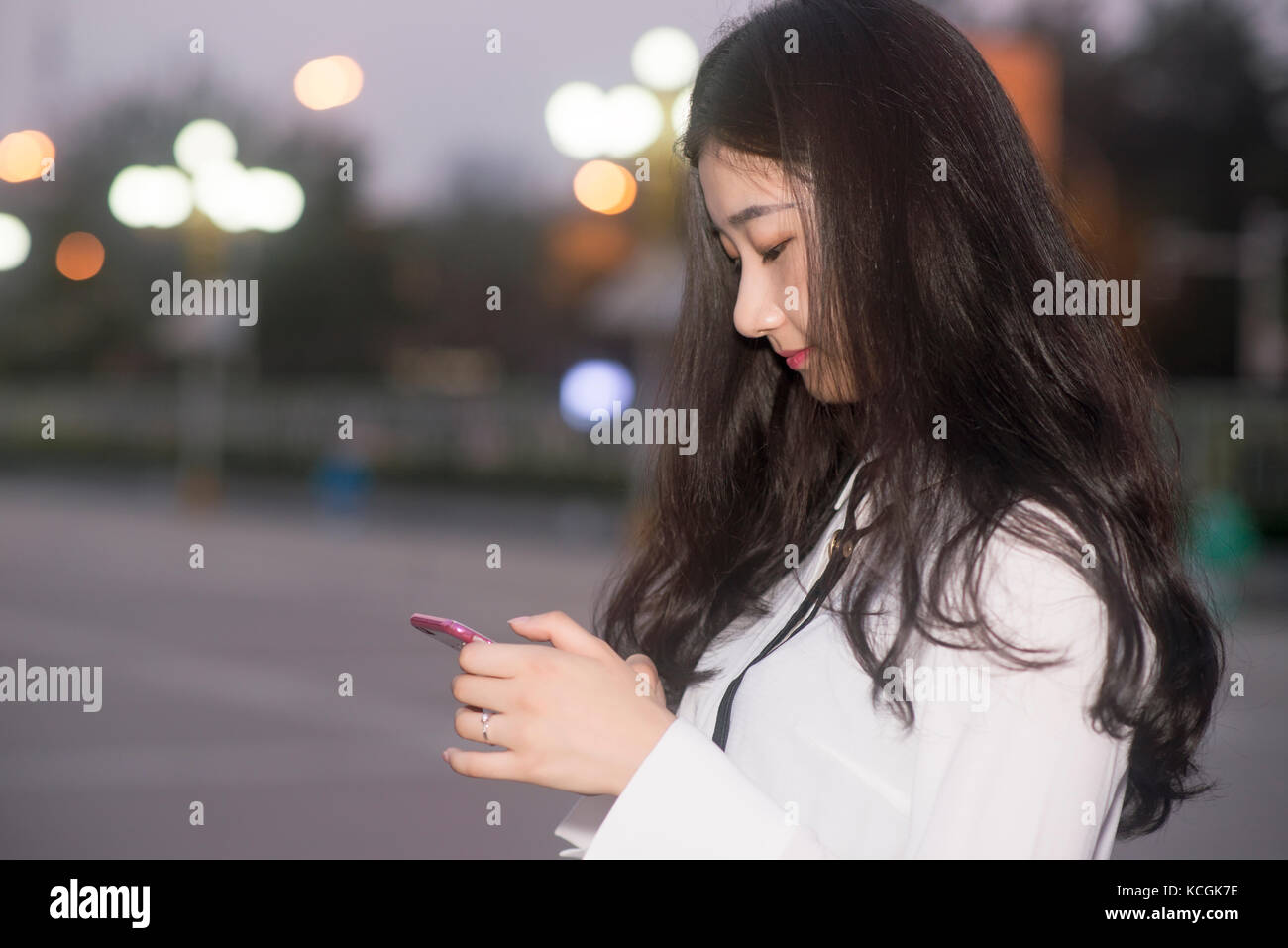 The young woman use a mobile phone at night Stock Photo - Alamy