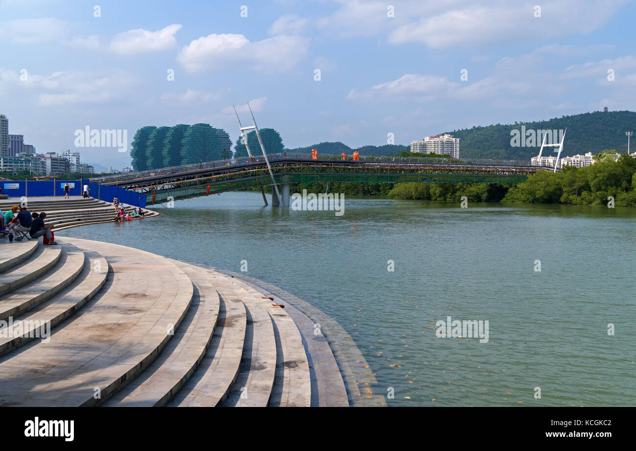 New pedestrian bridge is built across the Linchun River bank in the city of Sanya Stock Photo