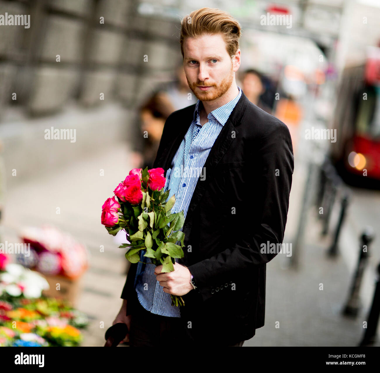 Man Carrying Roses Man standing with a bouquet of roses on the street Stock Photo - Alamy