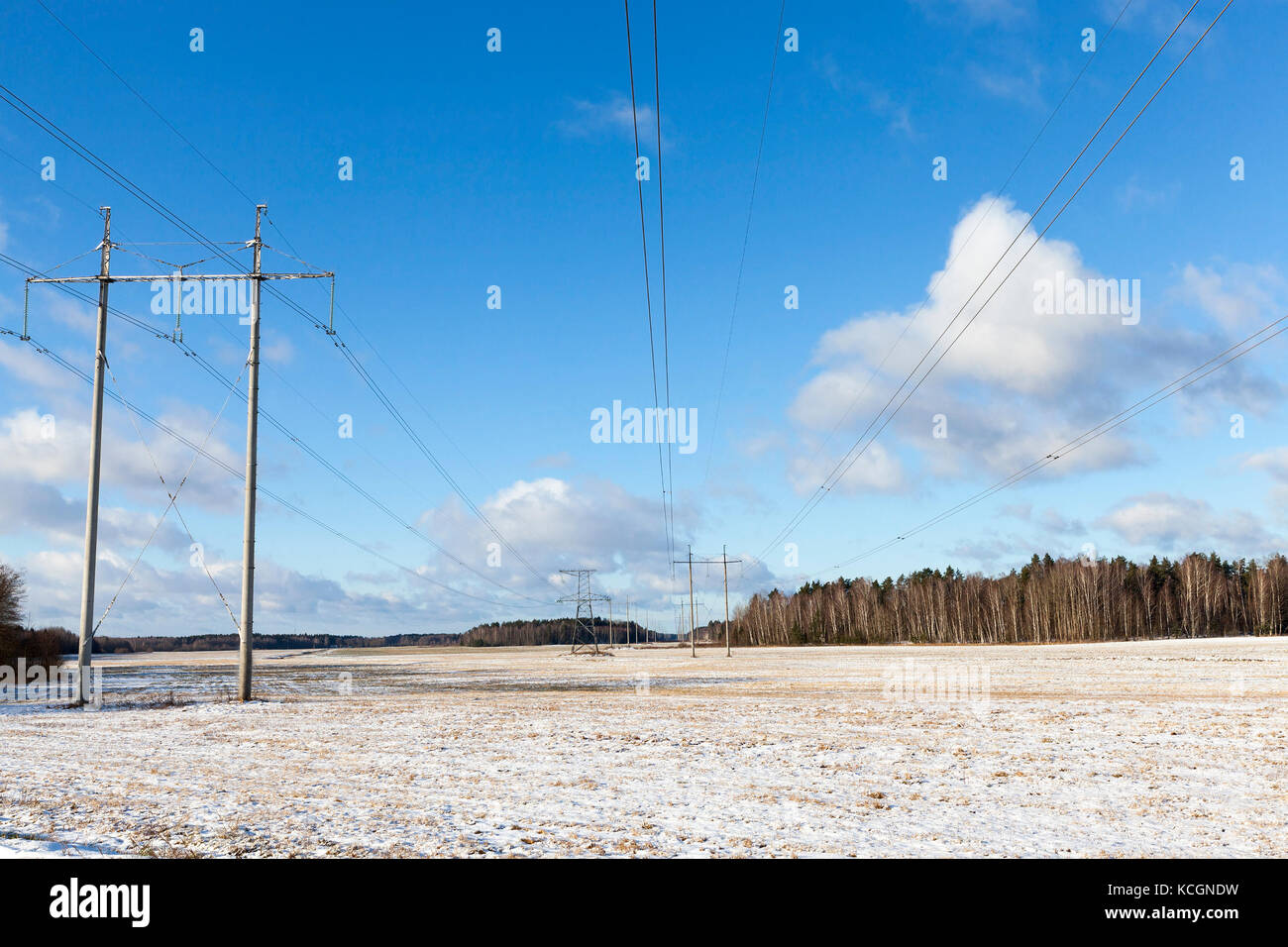 photo of high-voltage power lines in the winter season. Blue sky and ...