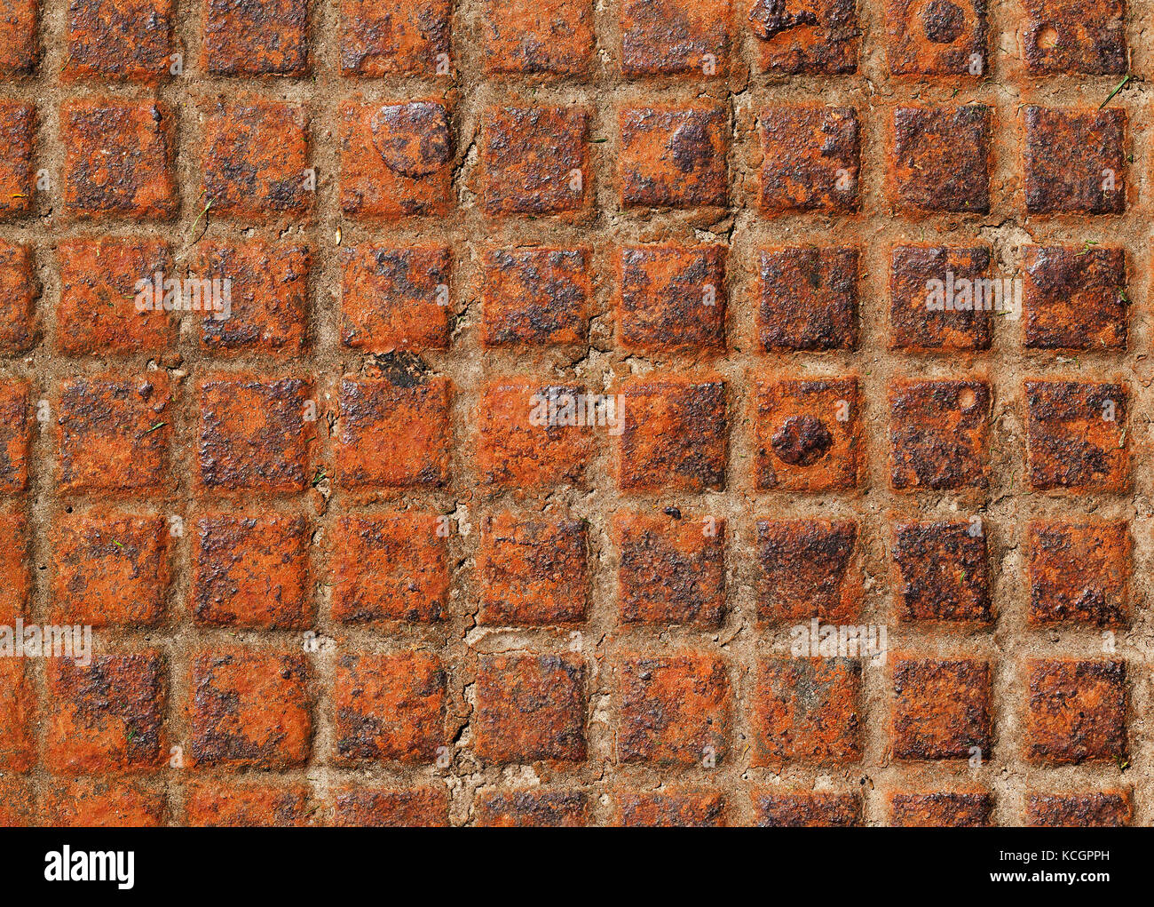 Rusty metal cover sewer. Photo of a close-up of an orange metal grill Stock Photo