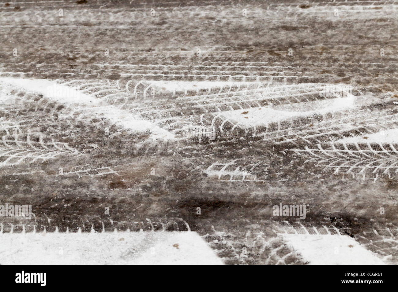 tracks in the snow driven by cars in the winter season Stock Photo - Alamy
