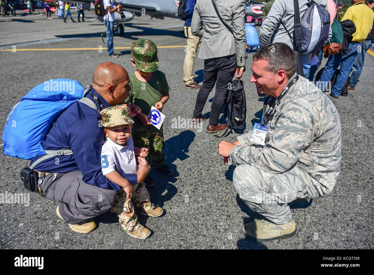 U.S. Air Force Capt. Stephen Hudson, the public affairs officer for the 169th Fighter Wing, speaks with local Colombians at José María Córdova International Airport during F-AIR 2017 in Rionegro, Colombia, July 13, 2017. United States military participation in the air show provides an opportunity to strengthen our military-to-military relationships with regional partners and provides the opportunity to meet with our Colombian air force counterparts and facilitate interoperability, which can be exercised in future cooperation events such as exercises and training. (U.S. Air National Guard photo Stock Photo