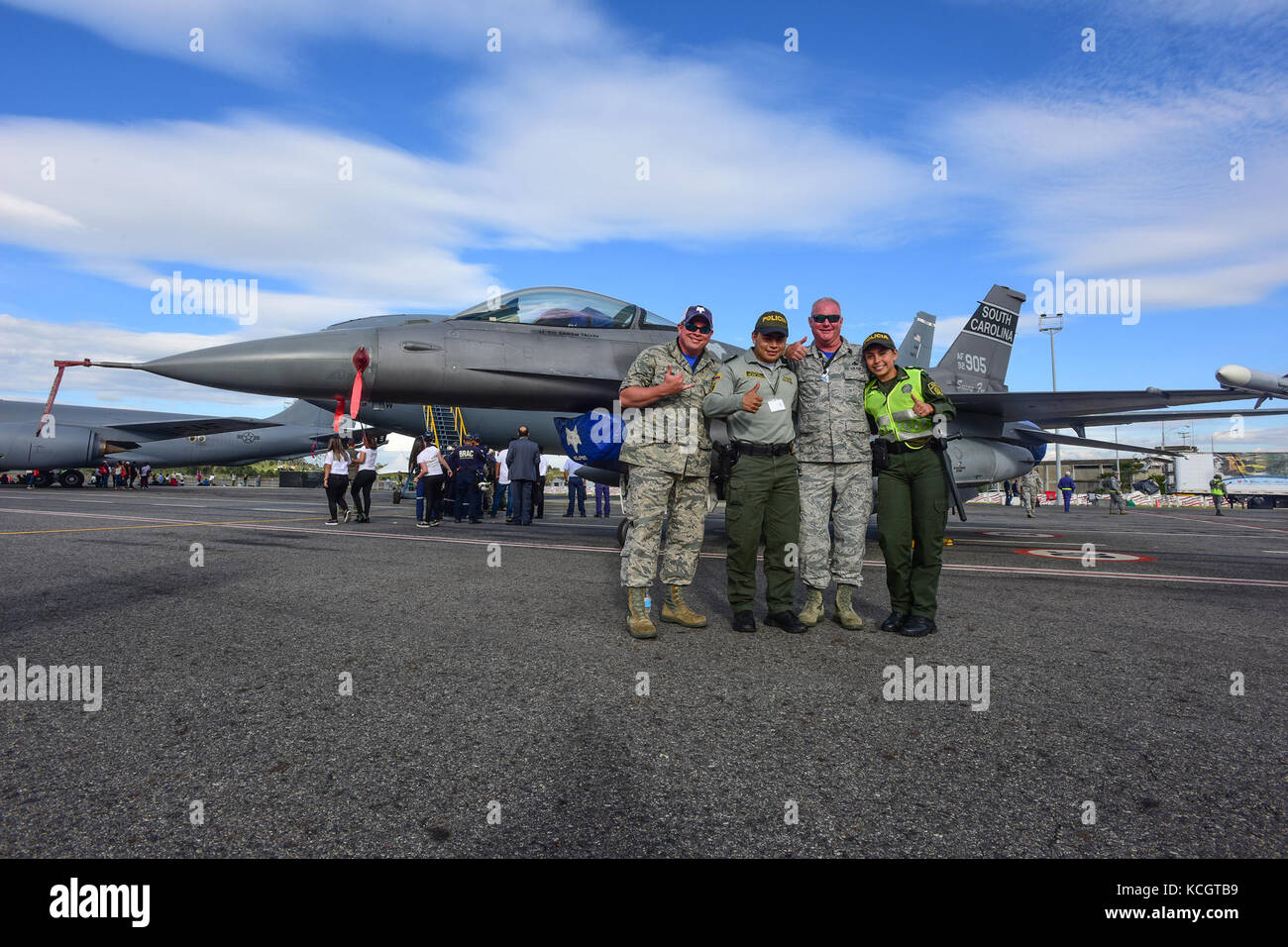 U.S. Air Force Master Sgt. Michael Glenn and Kenny Pearsall, both crew chiefs assigned to the 169th Aircraft Maintenance Squadron, pose for a photo with local law enforcement at José María Córdova International Airport during F-AIR 2017 in Rionegro, Colombia, July 13, 2017. United States military participation in the air show provides an opportunity to strengthen our military-to-military relationships with regional partners and provides the opportunity to meet with our Colombian air force counterparts and facilitate interoperability, which can be exercised in future cooperation events such as  Stock Photo