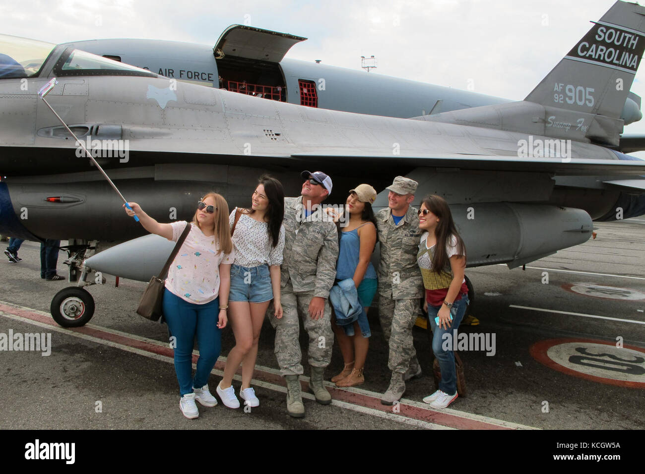 U.S. Air Force Senior Master Sgt. Charles Bowen (left) and Staff Sgt. Matthew Parent, both assigned to the South Carolina Air National Guard’s 169th Aircraft Maintenance Squadron, take a selfie with visitors to the Colombian Air Force’s Feria Aeronautica Internaccional – Colombia in Rionegro,  July 15, 2017. The South Carolina Air National Guard is supporting its State Partner with providing two F-16s to the air show at Rionegro, Antioquia, Colombia from July 13-16, 2017. The United States military participation in the air show provides an opportunity to strengthen our military-to-military rel Stock Photo