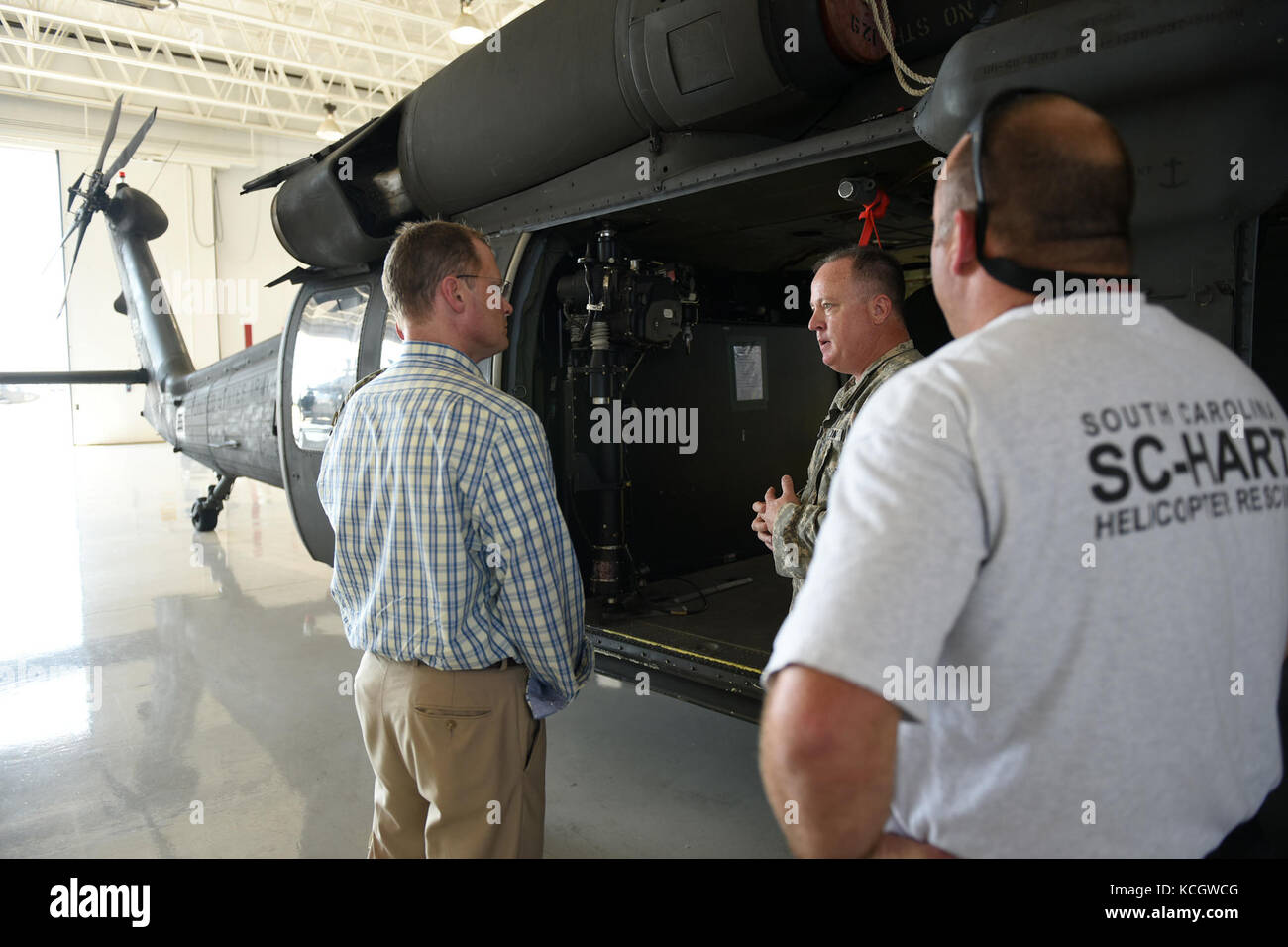 South Carolina Lieutenant Governor Kevin L. Bryant speaks with U.S. Army Chief Warrant Officer 4 Tripp Hutto, a UH-60 Blackhawk pilot, about the S.C. Helicopter Aquatic Rescue Team mission at McEntire Joint National Guard Base, July 21, 2017. Lt. Governor Bryant spoke with South Carolina Air and Army National Guard leadership about base missions and received a windshield tour of the installation with orientations of the various aircraft operated by South Carolina National Guard Airmen and Soldiers.  (U.S. Air National Guard photo by Master Sgt. Caycee Watson) Stock Photo