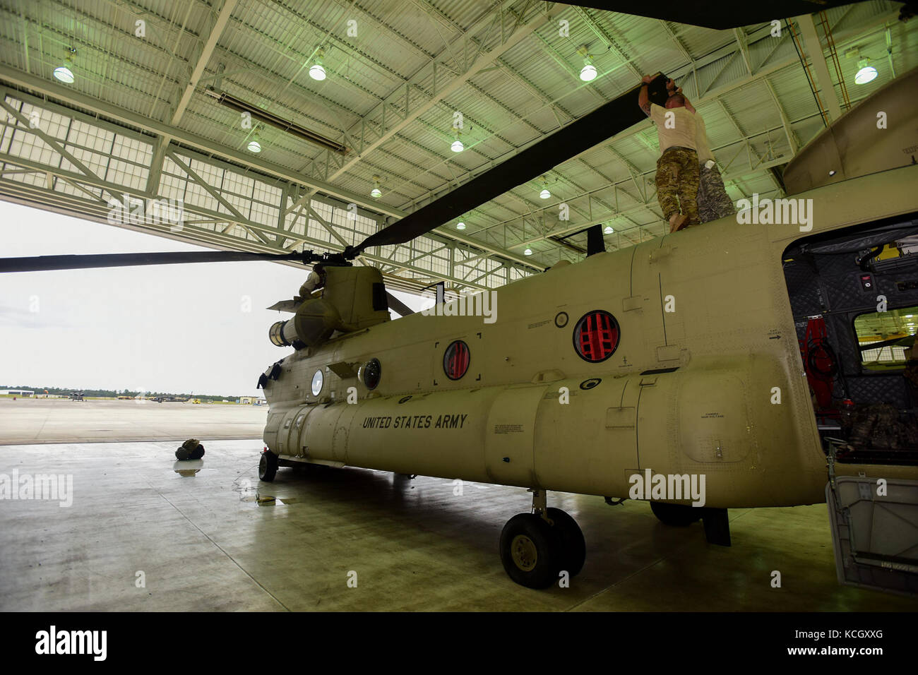U.S. Army Soldiers from the Ohio National Guard’s 3-238th General Aviation Support Battalion, perform routine maintenance on two Boeing CH-47F Chinook aircraft at McEntire Joint National Guard Base, S.C., before continuing on to Naval Air Station Cecil Field in Jacksonville, Florida as part of a response to Hurricane Irma, Sept. 12, 2017.  McEntire JNGB served as a transition point for the unit to refuel before heading on to Florida. Both aircraft recently responded to the damage and flooding in Texas caused by Hurricane Harvey by moving supplies and personnel. Hurricane Irma peaked as a Categ Stock Photo