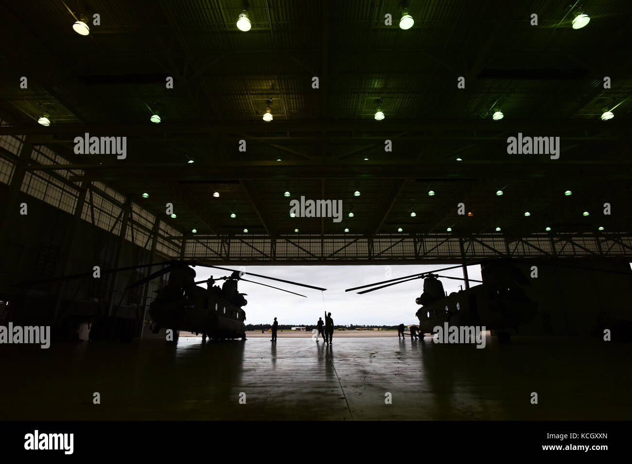 U.S. Army Soldiers from the Ohio National Guard’s 3-238th General Aviation Support Battalion, perform routine maintenance on two Boeing CH-47F Chinook aircraft at McEntire Joint National Guard Base, S.C., before continuing on to Naval Air Station Cecil Field in Jacksonville, Florida as part of a response to Hurricane Irma, Sept. 12, 2017.  McEntire JNGB served as a transition point for the unit to refuel before heading on to Florida. Both aircraft recently responded to the damage and flooding in Texas caused by Hurricane Harvey by moving supplies and personnel. Hurricane Irma peaked as a Categ Stock Photo