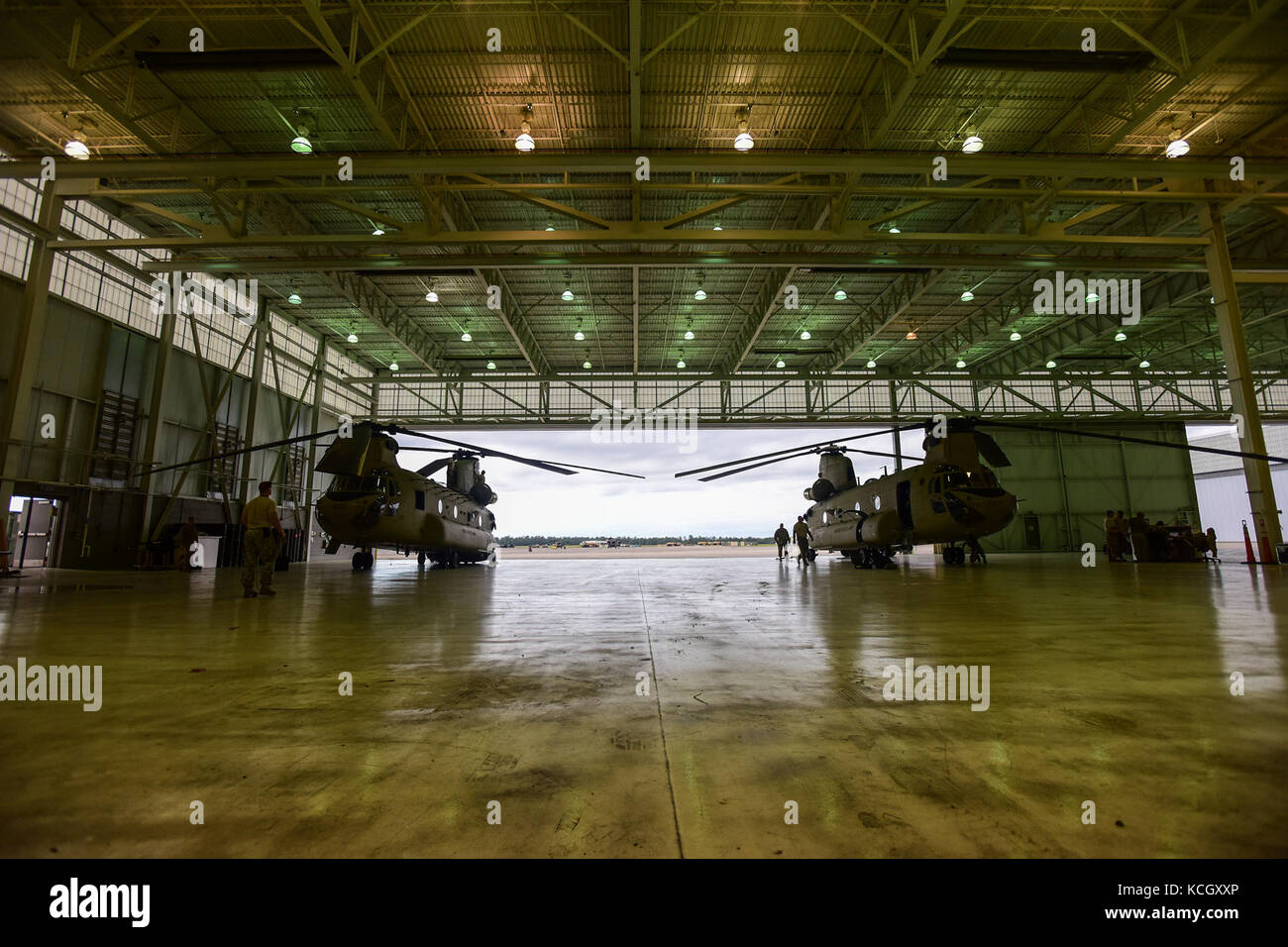 U.S. Army Soldiers from the Ohio National Guard’s 3-238th General Aviation Support Battalion, perform routine maintenance on two Boeing CH-47F Chinook aircraft at McEntire Joint National Guard Base, S.C., before continuing on to Naval Air Station Cecil Field in Jacksonville, Florida as part of a response to Hurricane Irma, Sept. 12, 2017.  McEntire JNGB served as a transition point for the unit to refuel before heading on to Florida. Both aircraft recently responded to the damage and flooding in Texas caused by Hurricane Harvey by moving supplies and personnel. Hurricane Irma peaked as a Categ Stock Photo