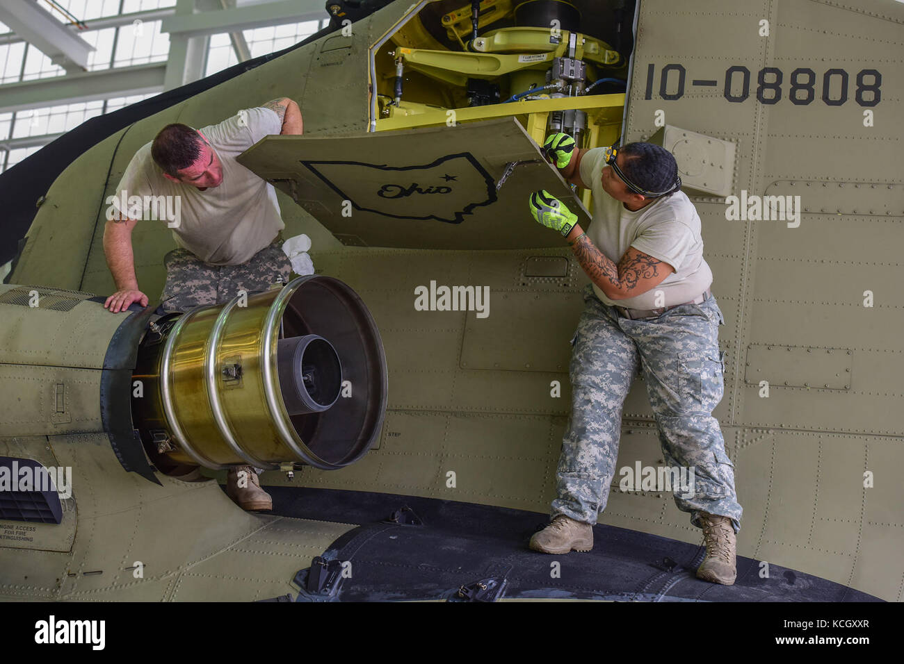 U.S. Army Soldiers from the Ohio National Guard’s 3-238th General Aviation Support Battalion, perform routine maintenance on two Boeing CH-47F Chinook aircraft at McEntire Joint National Guard Base, S.C., before continuing on to Naval Air Station Cecil Field in Jacksonville, Florida as part of a response to Hurricane Irma, Sept. 12, 2017.  McEntire JNGB served as a transition point for the unit to refuel before heading on to Florida. Both aircraft recently responded to the damage and flooding in Texas caused by Hurricane Harvey by moving supplies and personnel. Hurricane Irma peaked as a Categ Stock Photo