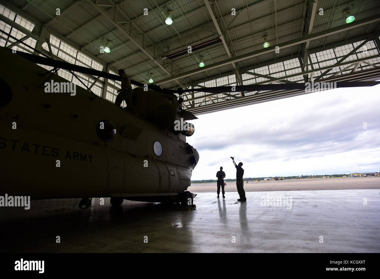 U.S. Army Soldiers from the Ohio National Guard’s 3-238th General Aviation Support Battalion, perform routine maintenance on two Boeing CH-47F Chinook aircraft at McEntire Joint National Guard Base, S.C., before continuing on to Naval Air Station Cecil Field in Jacksonville, Florida as part of a response to Hurricane Irma, Sept. 12, 2017.  McEntire JNGB served as a transition point for the unit to refuel before heading on to Florida. Both aircraft recently responded to the damage and flooding in Texas caused by Hurricane Harvey by moving supplies and personnel. Hurricane Irma peaked as a Categ Stock Photo