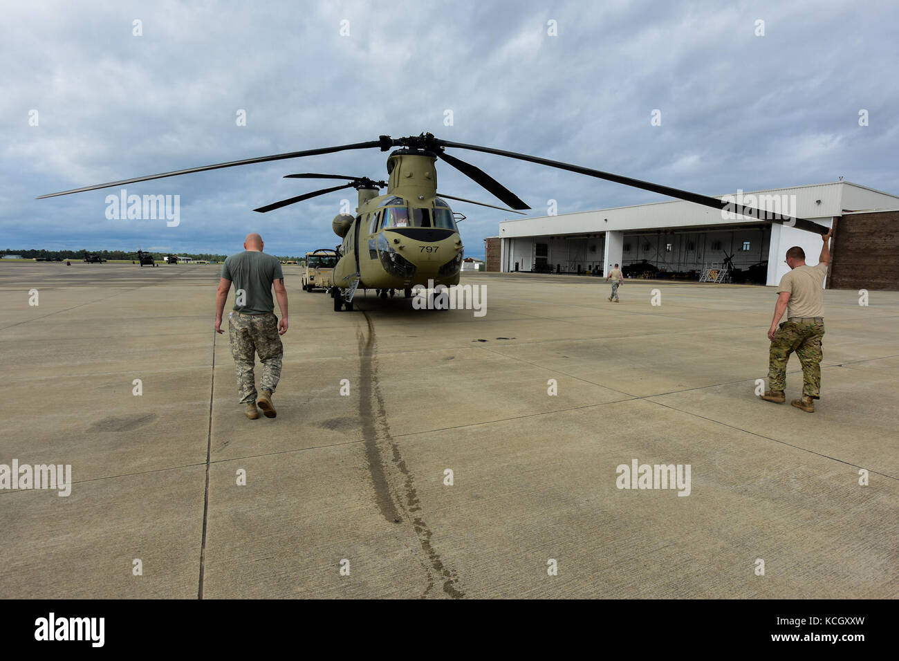 U.S. Army Soldiers from the Ohio National Guard’s 3-238th General Aviation Support Battalion, tow a Boeing CH-47F Chinook aircraft onto the ramp at McEntire Joint National Guard Base, S.C., before continuing on to Naval Air Station Cecil Field in Jacksonville, Florida as part of a response to Hurricane Irma, Sept. 12, 2017.  McEntire JNGB served as a transition point for the unit to refuel before heading on to Florida. Both aircraft recently responded to the damage and flooding in Texas caused by Hurricane Harvey by moving supplies and personnel. Hurricane Irma peaked as a Category 5 hurricane Stock Photo