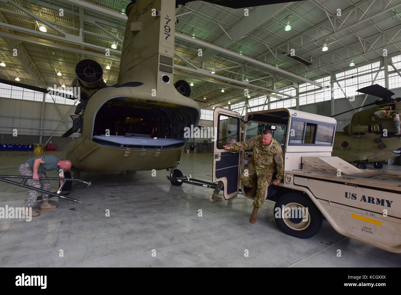 U.S. Army Soldiers from the Ohio National Guard’s 3-238th General Aviation Support Battalion, perform routine maintenance on two Boeing CH-47F Chinook aircraft at McEntire Joint National Guard Base, S.C., before continuing on to Naval Air Station Cecil Field in Jacksonville, Florida as part of a response to Hurricane Irma, Sept. 12, 2017.  McEntire JNGB served as a transition point for the unit to refuel before heading on to Florida. Both aircraft recently responded to the damage and flooding in Texas caused by Hurricane Harvey by moving supplies and personnel. Hurricane Irma peaked as a Categ Stock Photo