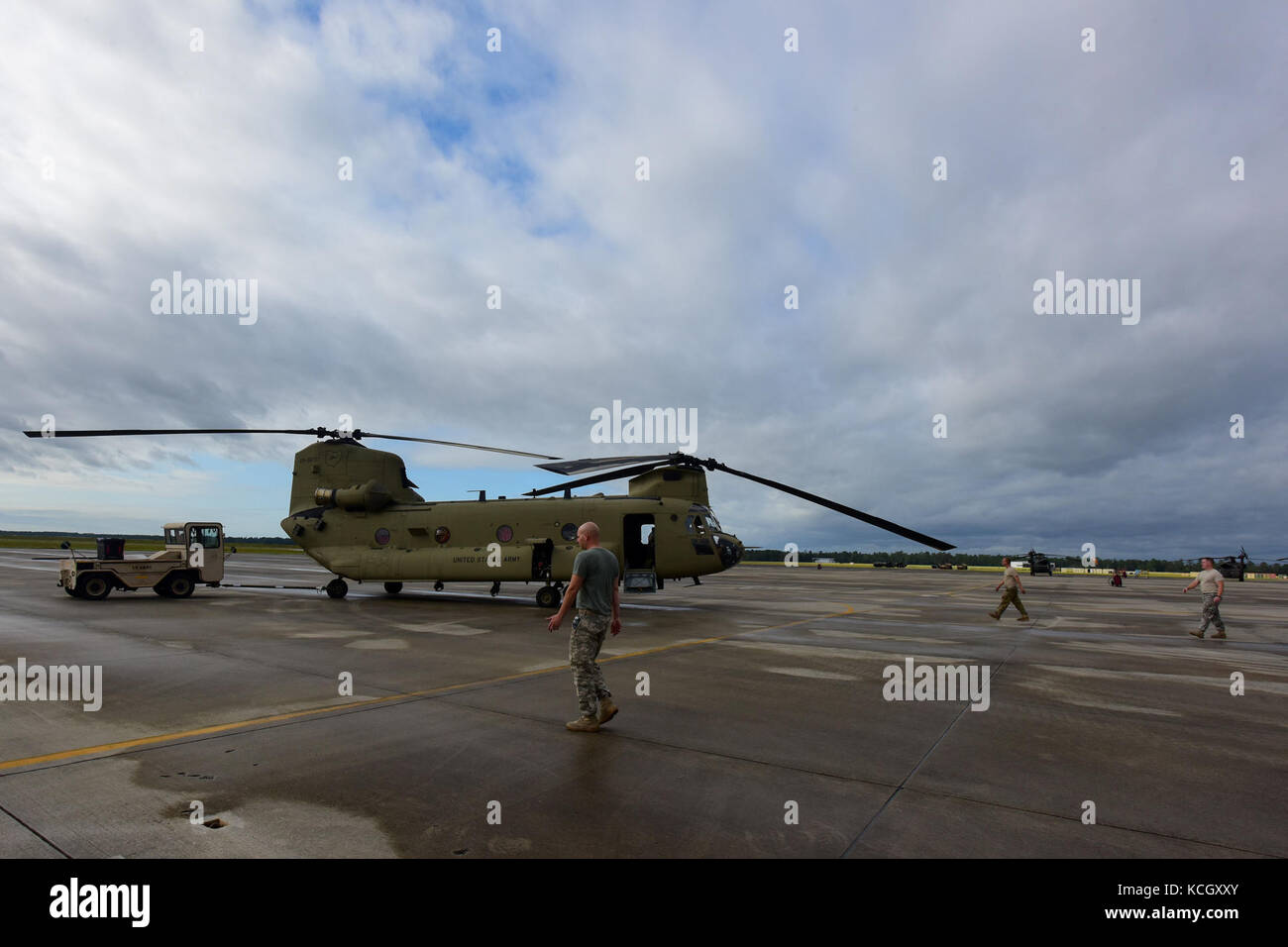 U.S. Army Soldiers from the Ohio National Guard’s 3-238th General Aviation Support Battalion, tow a Boeing CH-47F Chinook aircraft onto the ramp at McEntire Joint National Guard Base, S.C., before continuing on to Naval Air Station Cecil Field in Jacksonville, Florida as part of a response to Hurricane Irma, Sept. 12, 2017.  McEntire JNGB served as a transition point for the unit to refuel before heading on to Florida. Both aircraft recently responded to the damage and flooding in Texas caused by Hurricane Harvey by moving supplies and personnel. Hurricane Irma peaked as a Category 5 hurricane Stock Photo