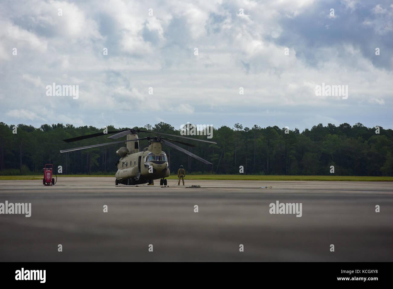 A U.S. Army crew chief from the Ohio National Guard’s 3-238th General Aviation Support Battalion, performs preflight checks on a Boeing CH-47F Chinook aircraft onto the ramp at McEntire Joint National Guard Base, S.C., before continuing on to Naval Air Station Cecil Field in Jacksonville, Florida as part of a response to Hurricane Irma, Sept. 12, 2017.  McEntire JNGB served as a transition point for the unit to refuel before heading on to Florida. Both aircraft recently responded to the damage and flooding in Texas caused by Hurricane Harvey by moving supplies and personnel. Hurricane Irma pea Stock Photo