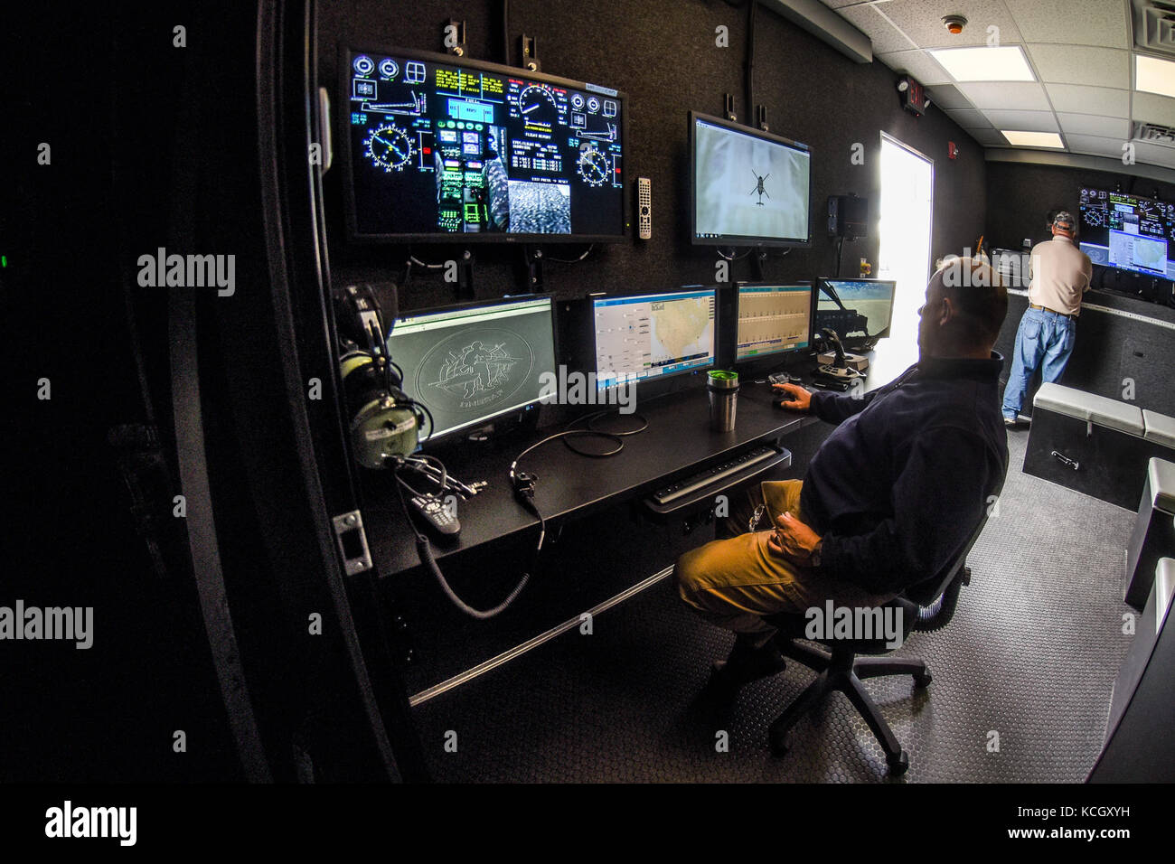 U.S. Army helicopter pilots Cpt. Chris Jones and Chief Warrant Officer Daniel Melogy, HHC 2-151st Security and Support Aviation Battalion (2-151st SSAB), S.C. Army National Guard, perform the first, official (logged training hours), training on the newly acquired LUH-72A Lakota Synthetic Flight Training System (SFTS), Army Aviation Support Facility (loc. 2), Donaldson Center, Greenville, South Carolina, September 12, 2017. Each LUH-72A SFTS is comprised of a tractor-trailer containing the LUH-72A flight training device (FTD) with a two-seat cockpit, six Virtual Reality Scene Generators (VRSG l Stock Photo