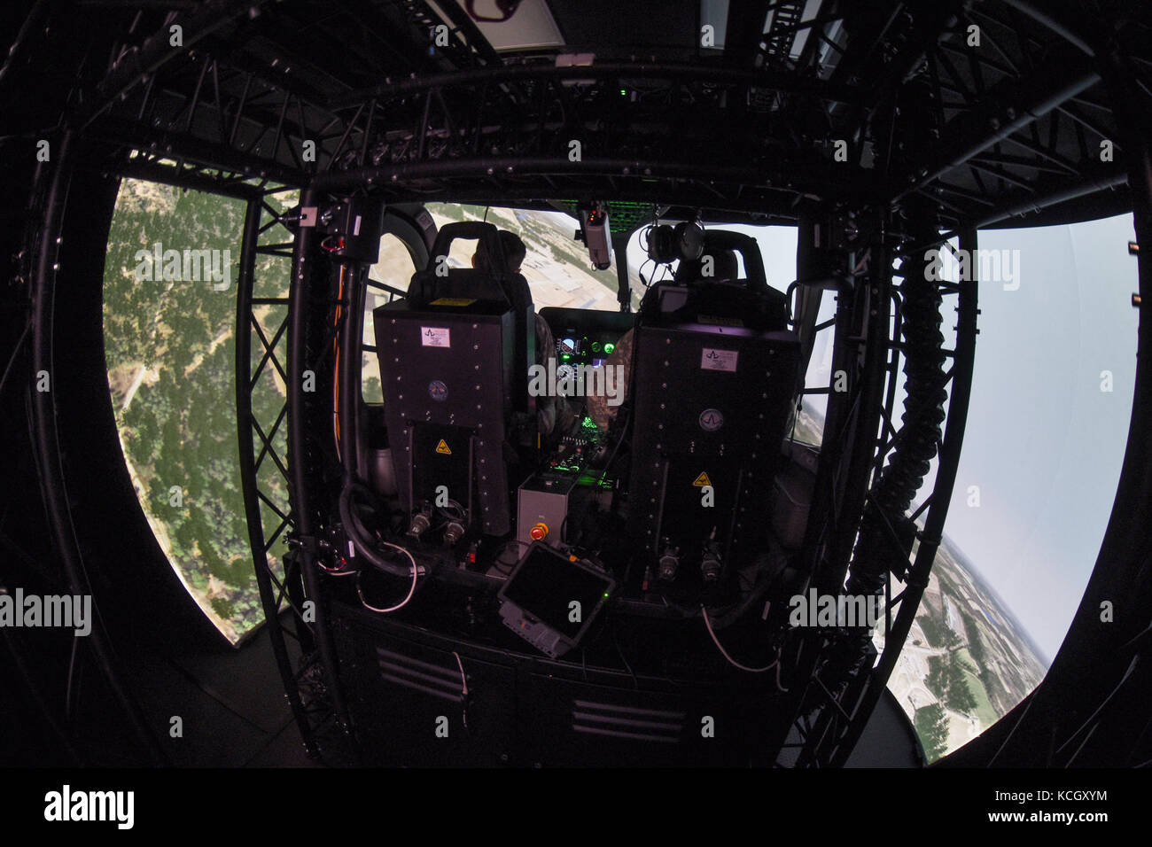 U.S. Army helicopter pilots Cpt. Chris Jones and Chief Warrant Officer Daniel Melogy, HHC 2-151st Security and Support Aviation Battalion (2-151st SSAB), S.C. Army National Guard, perform the first, official (logged training hours), training on the newly acquired LUH-72A Lakota Synthetic Flight Training System (SFTS), Army Aviation Support Facility (loc. 2), Donaldson Center, Greenville, South Carolina, September 12, 2017. Each LUH-72A SFTS is comprised of a tractor-trailer containing the LUH-72A flight training device (FTD) with a two-seat cockpit, six Virtual Reality Scene Generators (VRSG l Stock Photo