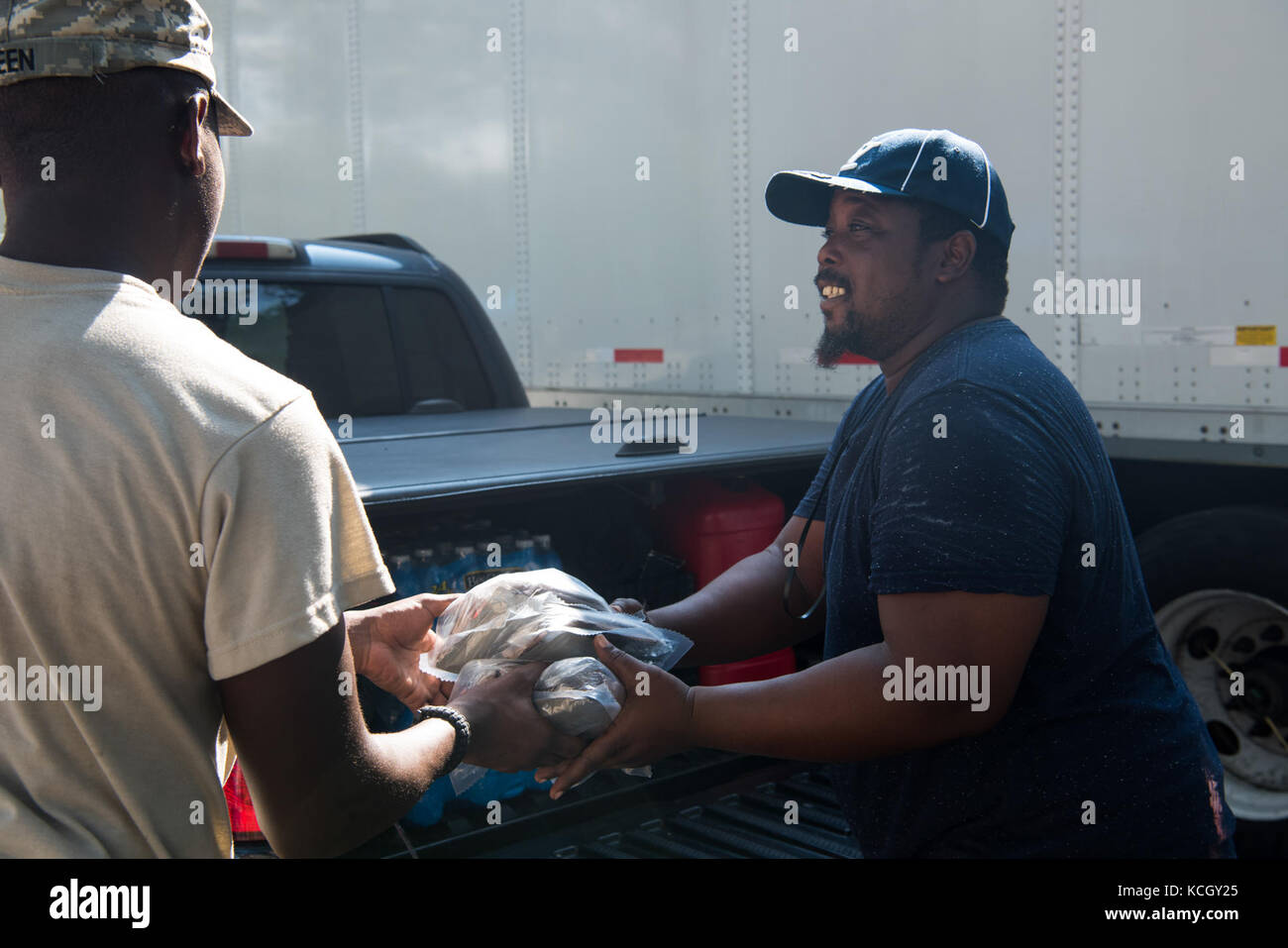 U.S. Soldiers from C Company, 1-118th Infantry, 218th Maneuver Enhancement Brigade, South Carolina Army National Guard distributed food and water in Hillsborough County, FL Sept. 15, 2017. The Soldiers are in Florida providing support during the recovery efforts after Hurricane Irma came ashore and devastated the state.  (U.S. Army National Guard Photo by Staff Sgt. Erica Knight, 108th Public Affairs Detachment) Stock Photo