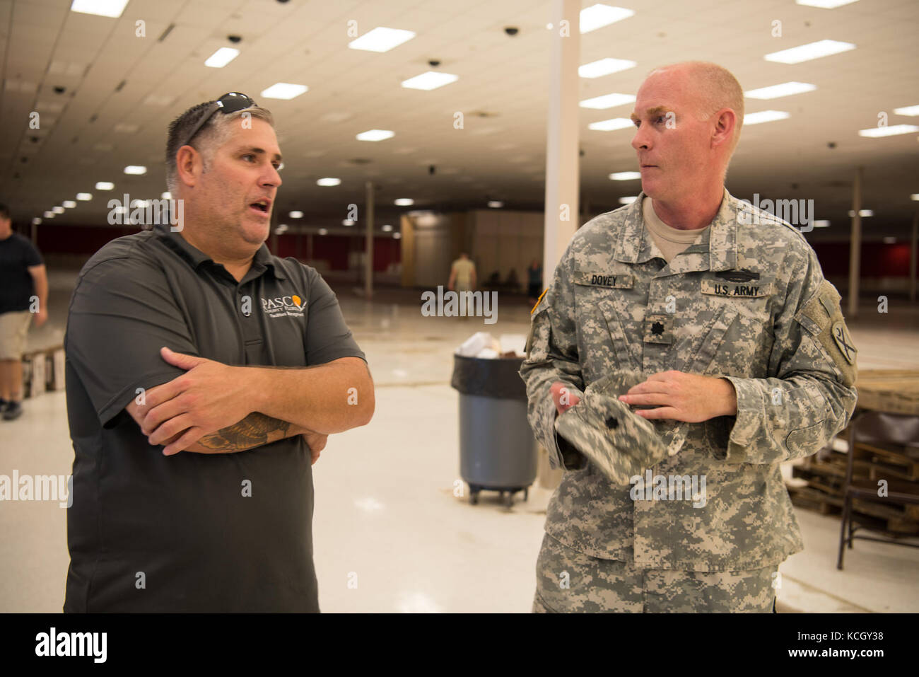 U.S. Army Lt. Col. Michael Dovey, commander, 1st Battalion,118th Infantry Regiment, 218th Maneuver Enhancement Brigade, South Carolina Army National Guard talks to a county representative at a donation center in Pasco County, FL where Soldeirs were collecting donated goods Sept. 16, 2017. The Soldiers are in Florida providing support during the recovery efforts after Hurricane Irma came ashore and devastated the state.  (U.S. Army National Guard Photo by Staff Sgt. Erica Knight, 108th Public Affairs Detachment) Stock Photo