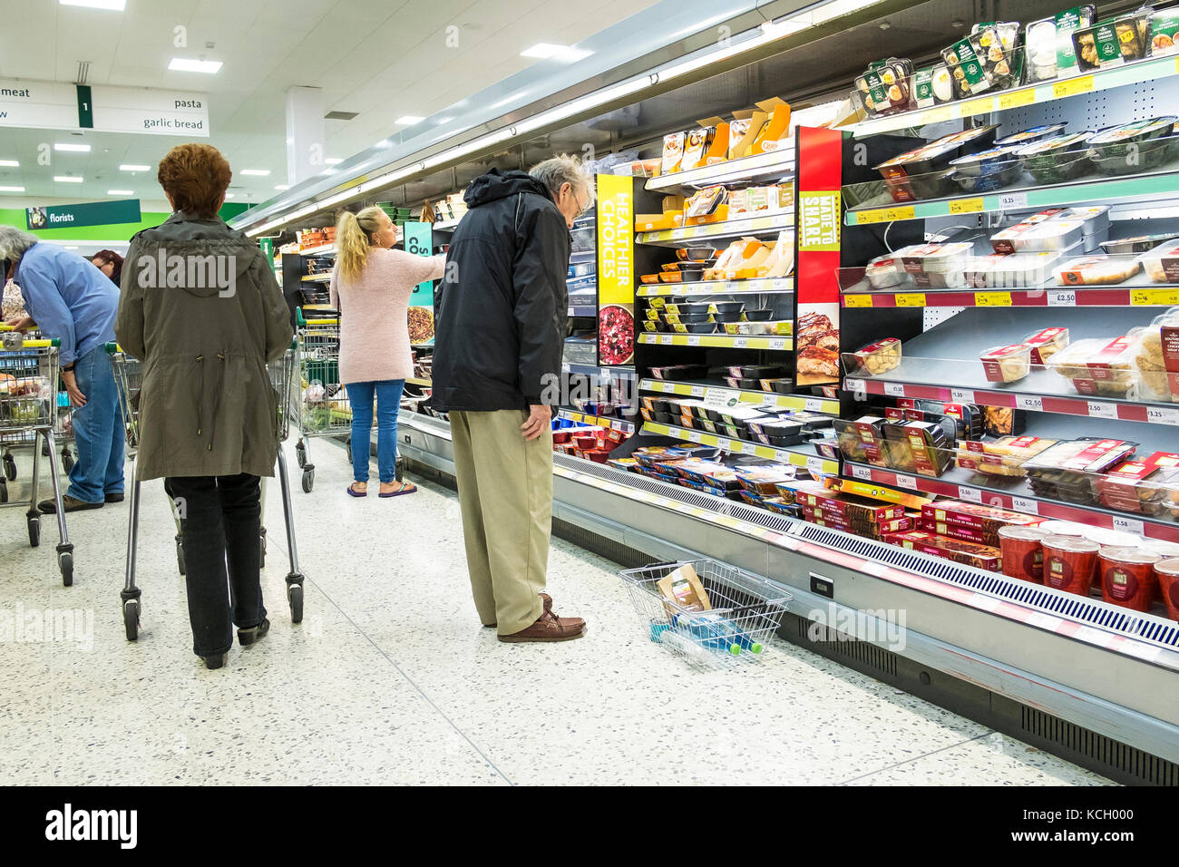 Shopping in a supermarket - shoppers in a Morrisons Supermarket. Stock Photo