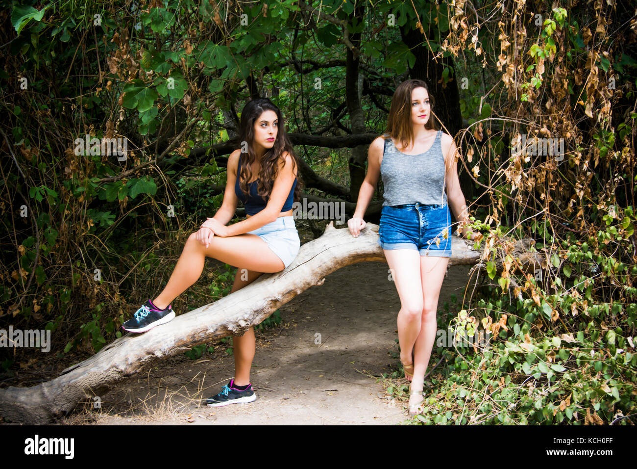 Two beautiful women hiking in nature on a mountain road Stock Photo - Alamy