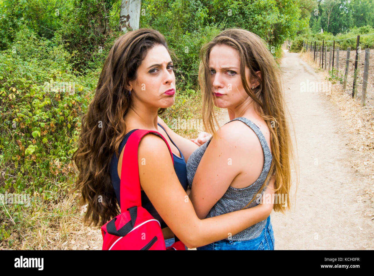 Two beautiful women hiking in nature on a mountain road Stock Photo - Alamy