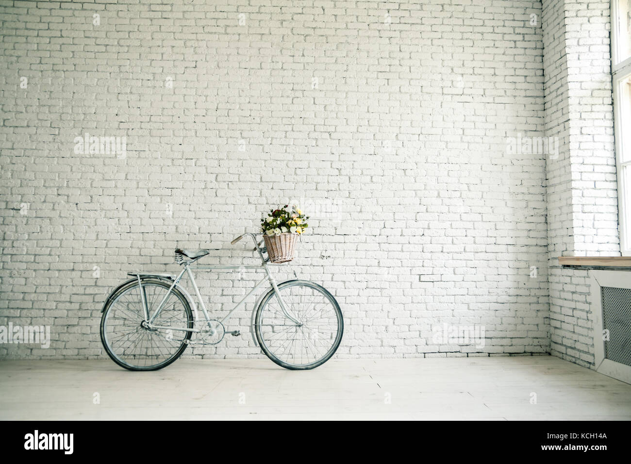 Retro bicycle on roadside with vintage brick wall background, Stock Photo