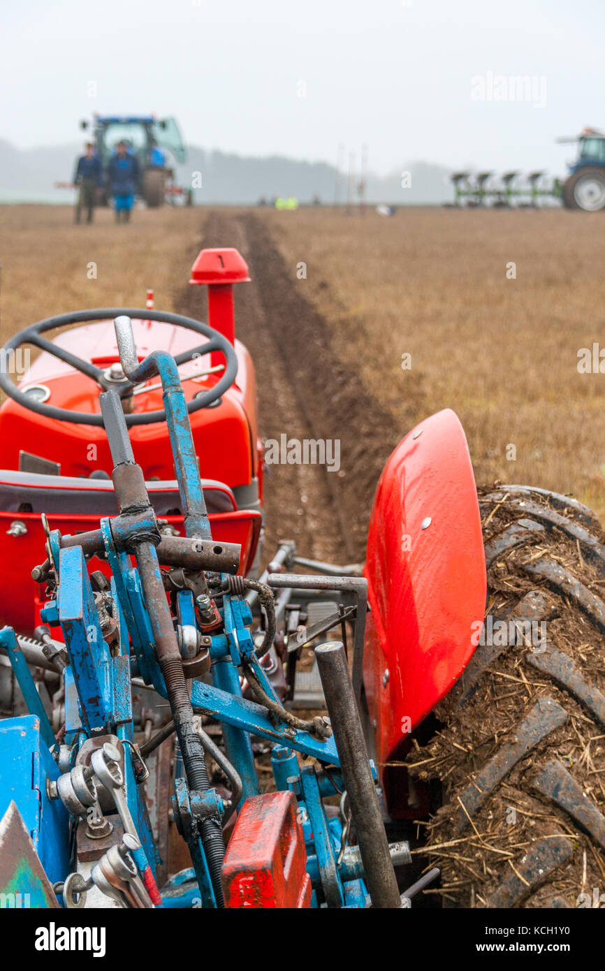 Ploughing a strait furrow Massey Ferguson tractor at a ploughing match Stock Photo