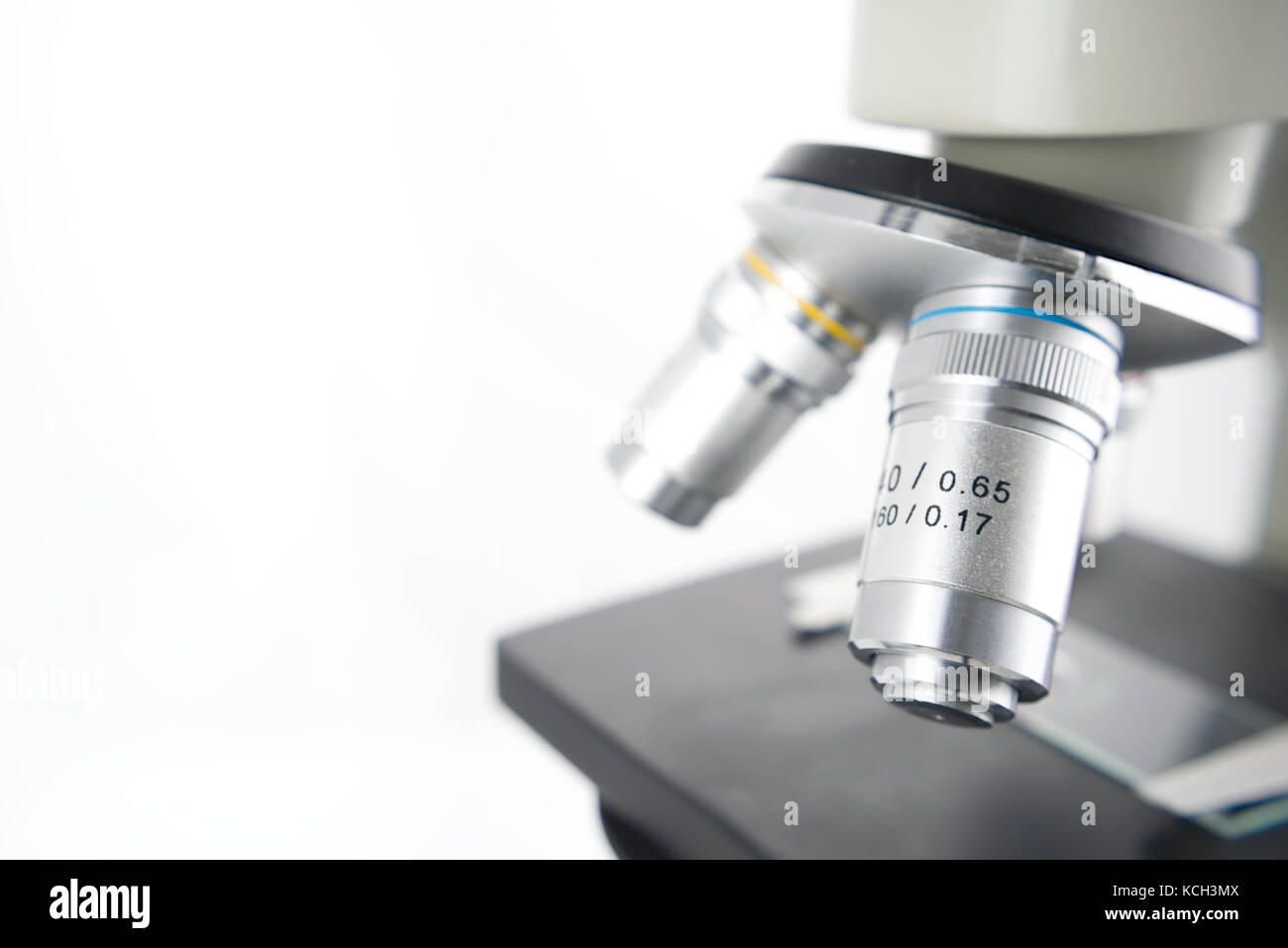 Close up of the lenses of a microscope on white background, Scientific ...