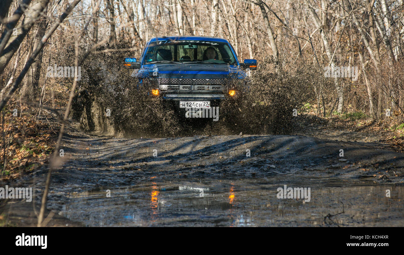 Khabarovsk, Russia - october 20, 2016: Ford F150 Raptor SUV is on the road driving on dirt . pickup Stock Photo