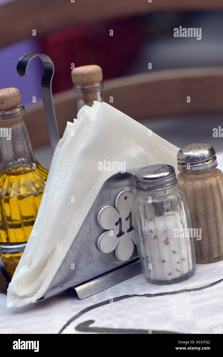 typically greek condiments on a table with napkins on a table place