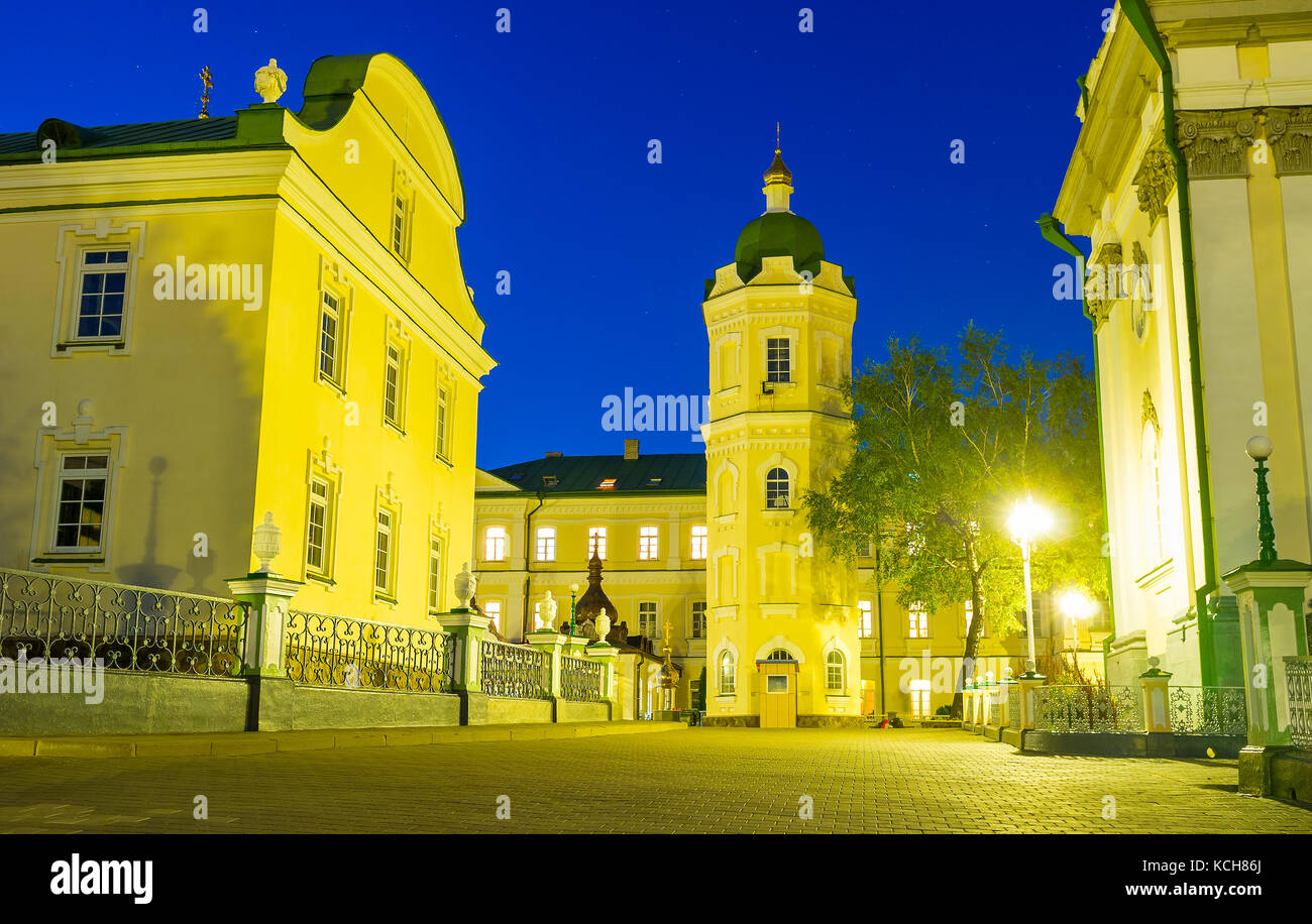 The evening view on courtyard of Pochaev Lavra with water tower in the middle, Pochaev, Ukraine Stock Photo