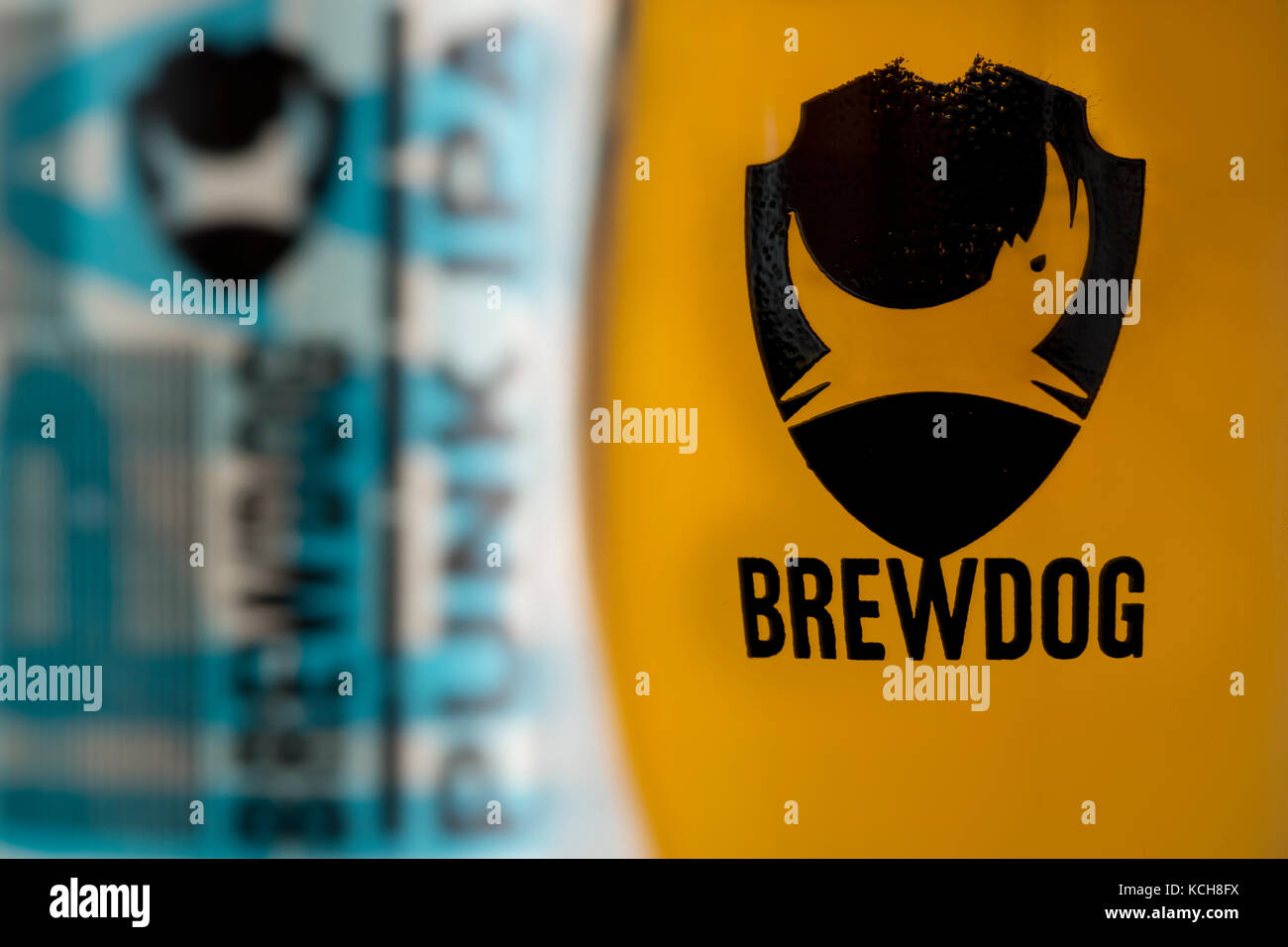 A glass full of beer featuring the logo of the Scottish company BrewDog, stands in front of a bottle of Punk IPA, also produced by the brewery. Stock Photo