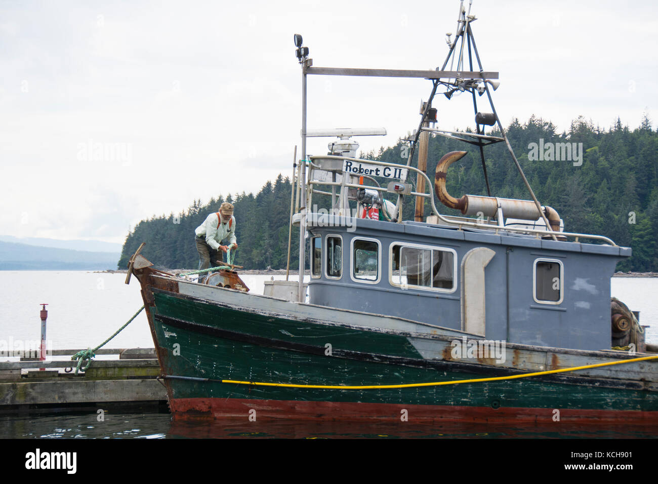 Man tying up workboat at Sointula, Malcolm Island, Vancouver Island, British Columbia, Canada Stock Photo